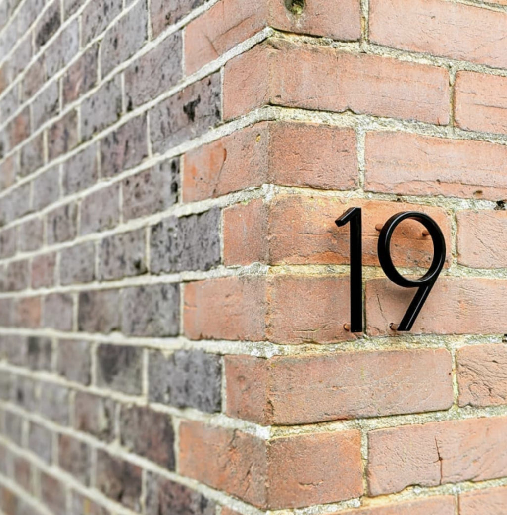 Numéro de maison noir avec chiffres en relief